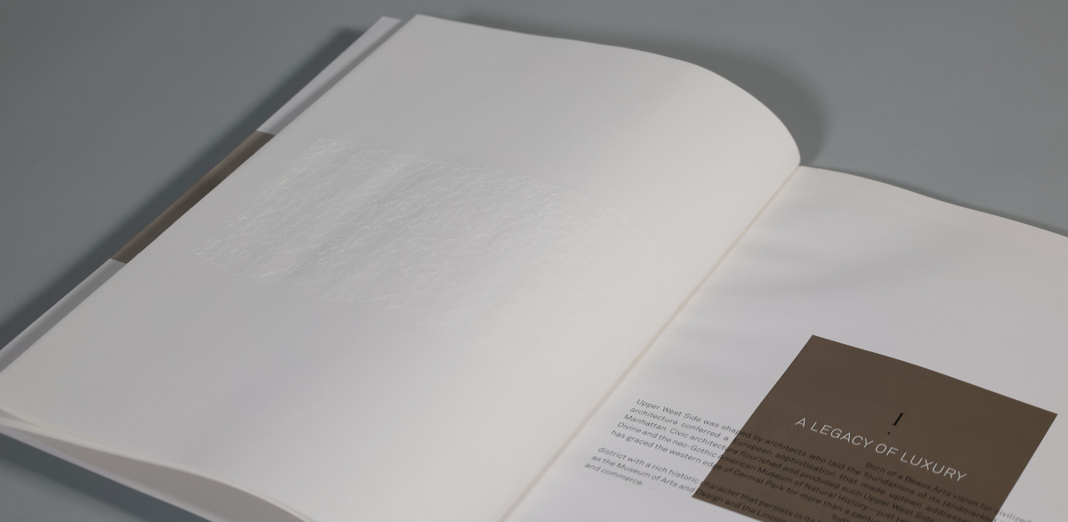inside spread of 207w79 luxury brochure showing the debossed vellum sheet