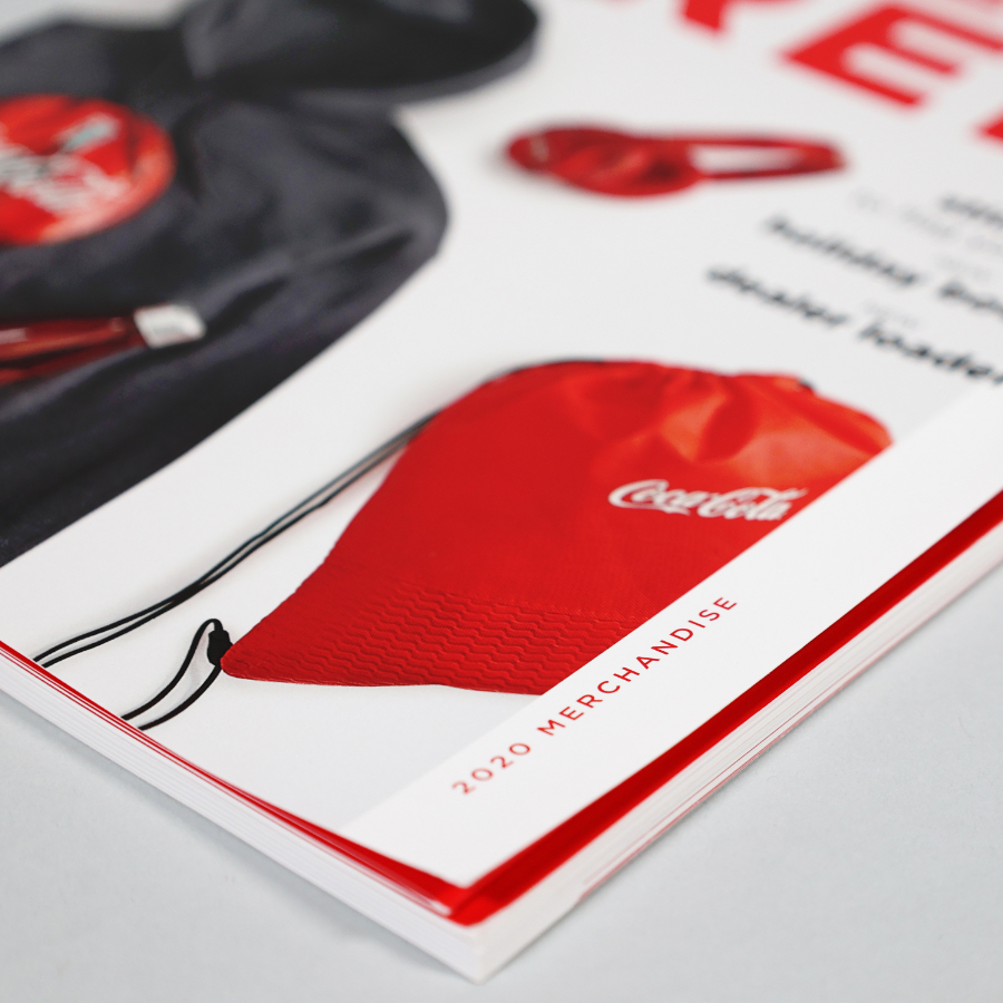 Closeup of Staples Coca-Cola Catalog with visuals of promotional products such as red drawstring bag